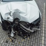 Total accident of a white car after hitting a lamppost. Frontal collision. Deployed airbags during